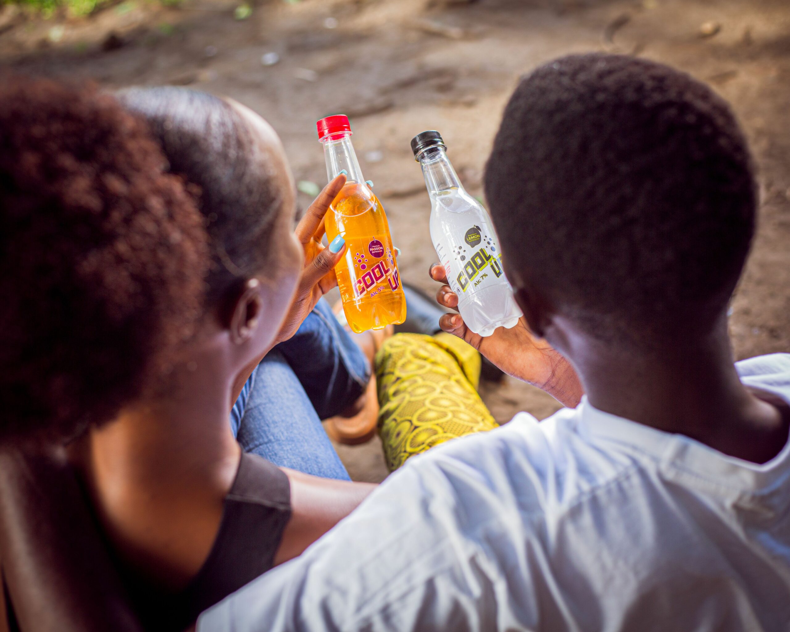 Brand tracking research in Africa, couple holding soda bottles