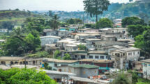 Panoramic view with parabolic tin roofs and palm trees of the African city of Libreville, capital of Gabon
