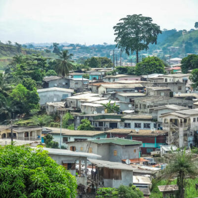 Panoramic view with parabolic tin roofs and palm trees of the African city of Libreville, capital of Gabon